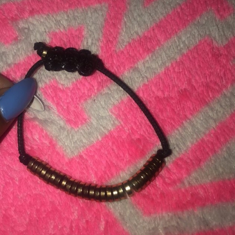 Two gold and black bracelets